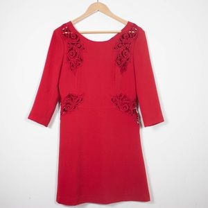 Red Long-sleeved dress with a scoop neckline and cut out embroidery detail.